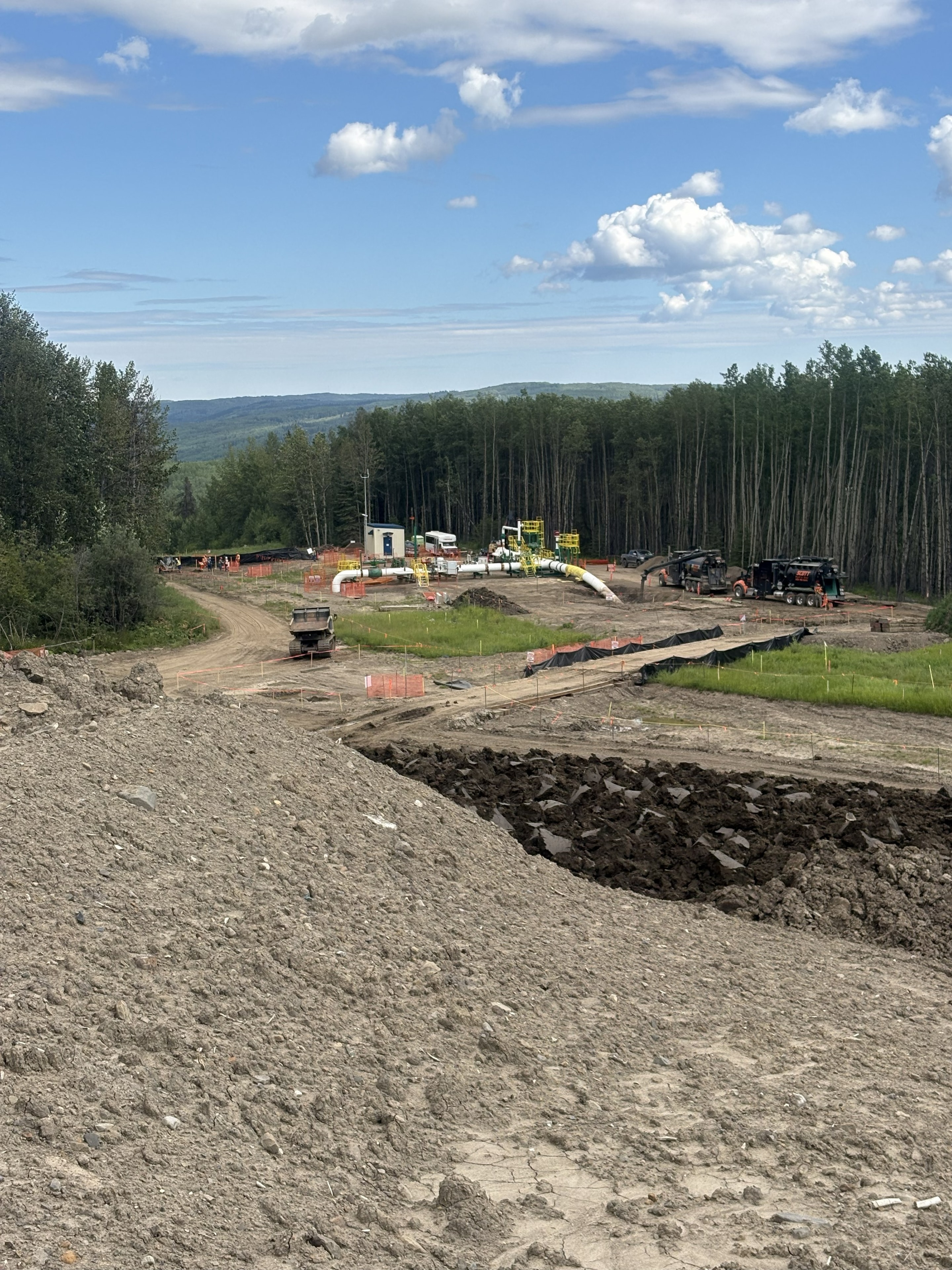 Pipeline construction site in forested landscape